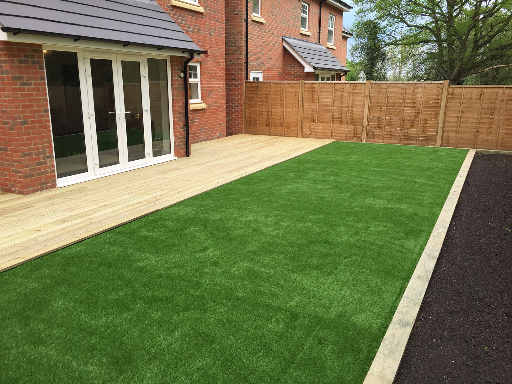 Full garden view of finished lawn and decking project