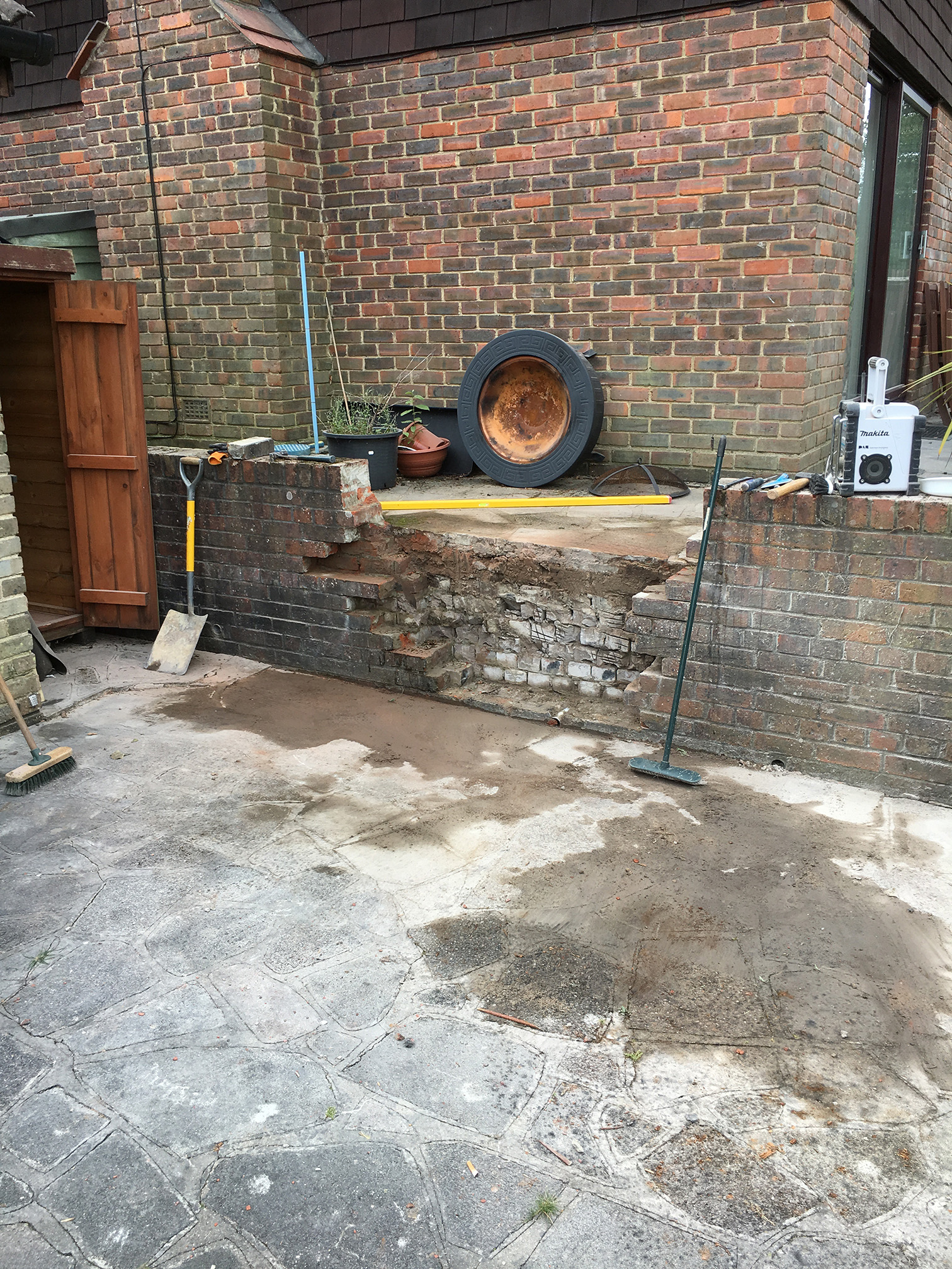 Damaged brick wall before repair